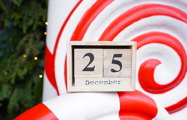 Wooden calendar with Christmas date. Close-up.