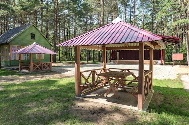 Wooden camping arbors with all conviniences in a pine forest