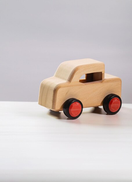 Photo wooden car toy on white background generative ai