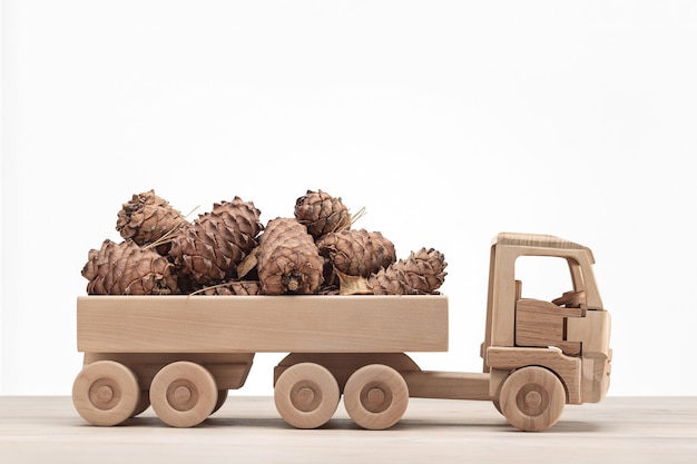 Wooden car toy with pine cones