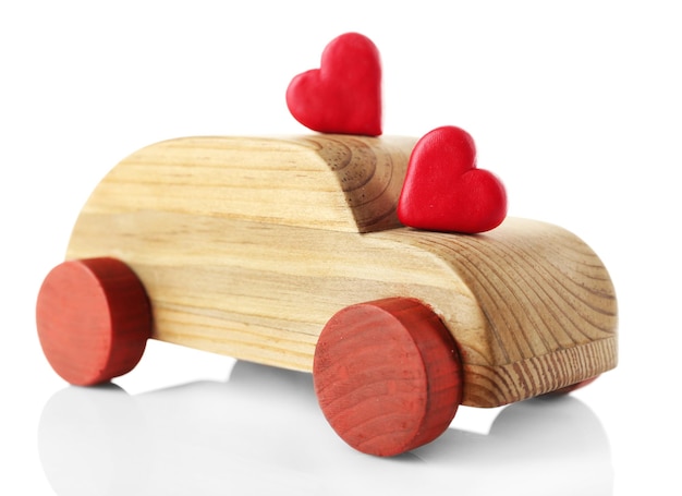 Wooden car with little red hearts isolated on white