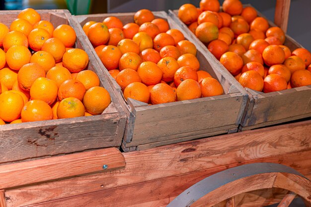 Wooden cart with oranges in a wooden box