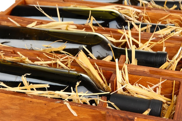 Wooden case with wine bottles close up