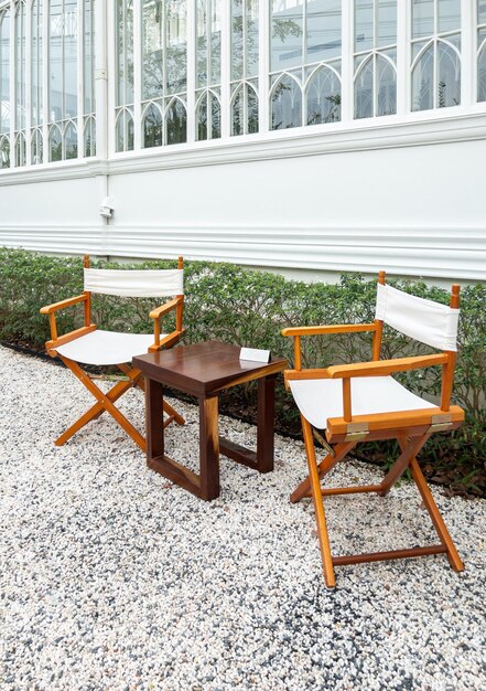 The wooden chair and table are set for coffee time