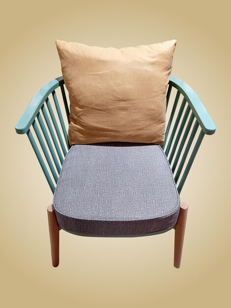 Photo wooden chair with soft pillow isolated on light brown background