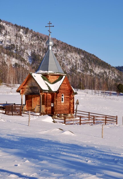 wooden chapel in the altai mountains a small orthodox chapel with a hipped roof