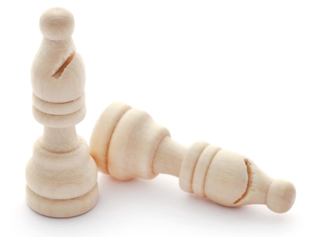 Wooden chess bishops over white background