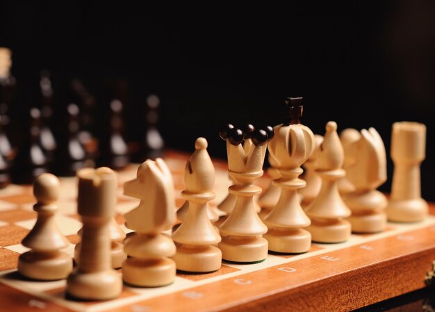 Premium Photo  Wooden chessboard with figures in light and dark brown  tones isolate on a white background