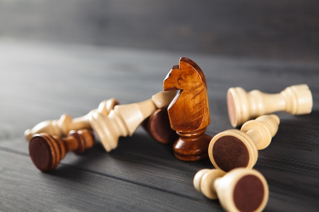 Wooden chess pieces on wooden background