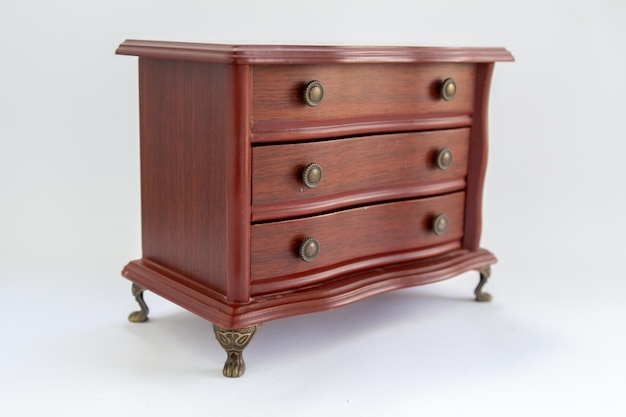 Wooden chest of drawers on a white background