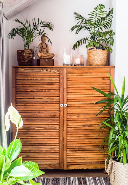 wooden chest of drawers with decorations and flowers in the interior