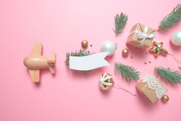 Wooden children's plane on a pink background