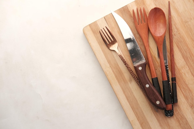 Wooden chopping board on black background top down