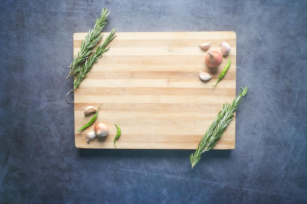 Wooden chopping board on black background top down