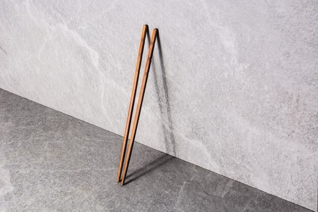 Wooden chopsticks on gray stone background