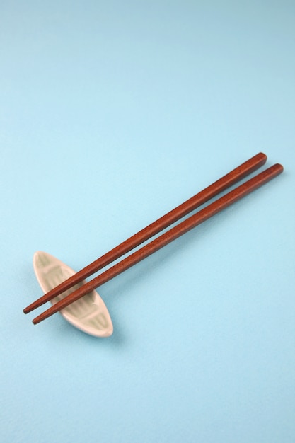 wooden chopsticks on sky blue  