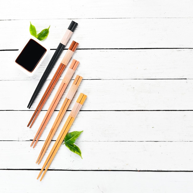 Wooden chopsticks and soy sauce A set of sticks for Asian cuisine Top view Free space for your text