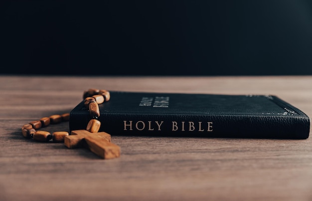 Wooden Christian cross on bible