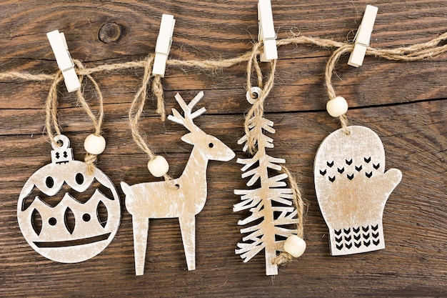 Wooden christmas decoration hanging over wooden background