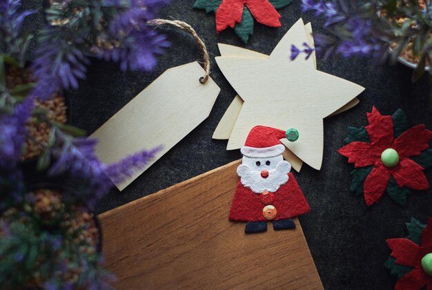 A wooden christmas decoration with a santa figure on the top of it.