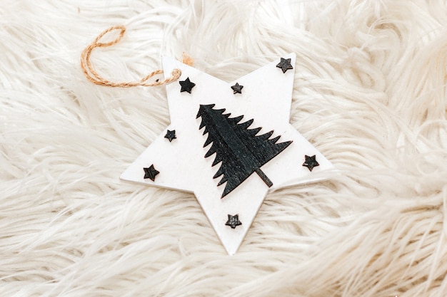 Photo wooden christmas toys on a fluffy white background.