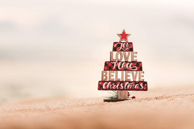 Photo wooden christmas tree toy on the beach rustic style