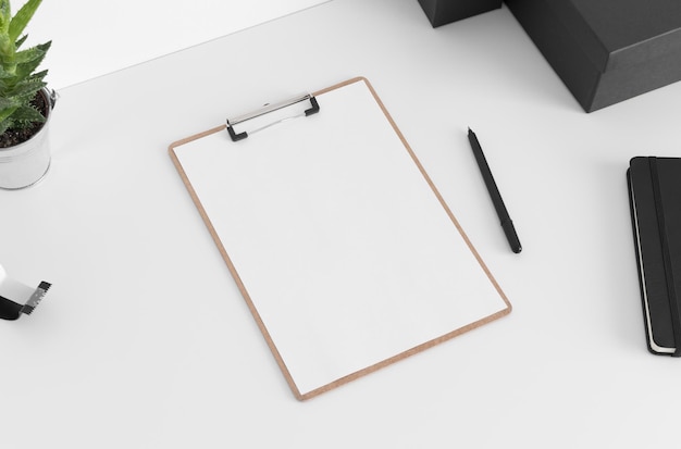 Photo wooden clipboard mockup wtih workspace accessories on a white table