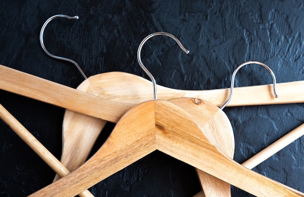 Wooden clothes hanger on black background.