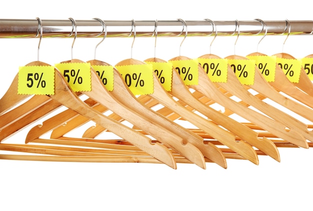 Wooden clothes hangers as sale symbol on white