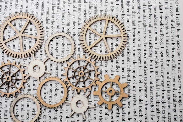 Wooden cogwheels on a book Industry concept information