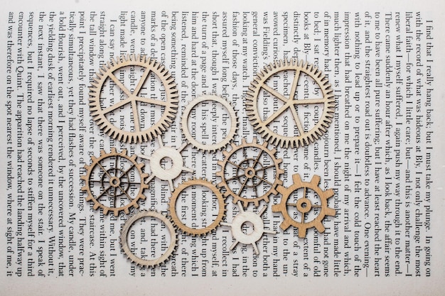 Wooden cogwheels on a page of a book Industry concept information