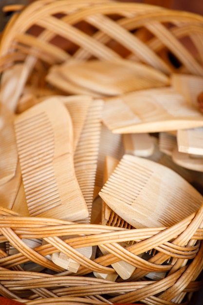 Wooden combs are in a wicker basket. view from above