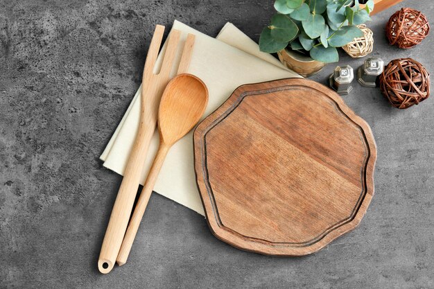 Wooden cooking utensils on grey background