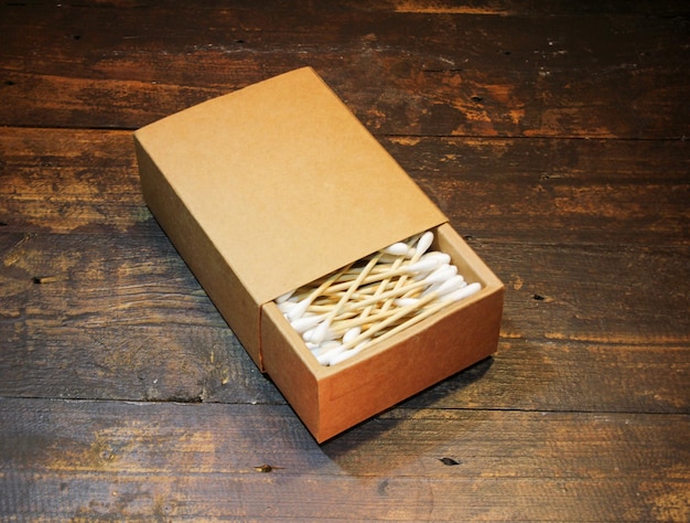 Wooden cotton buds on a wooden background.