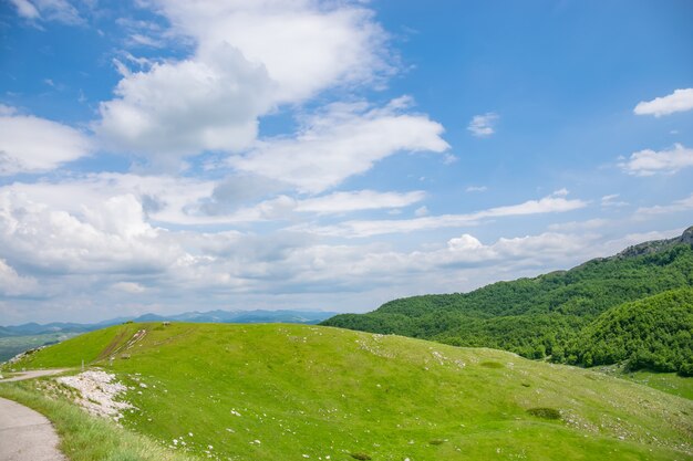 美しい山の斜面にある木製の居心地の良いベンチ