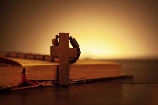 Wooden cross on the book