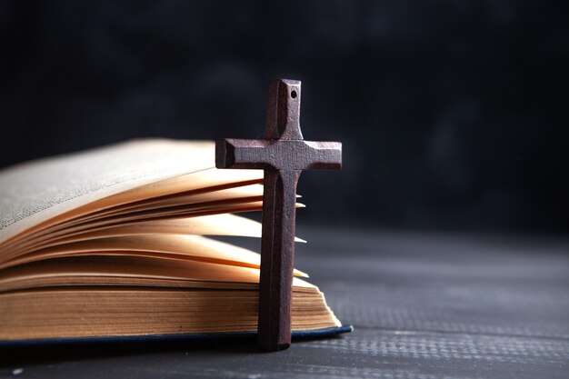 Wooden cross on the book