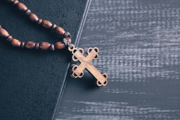 Wooden cross on the book