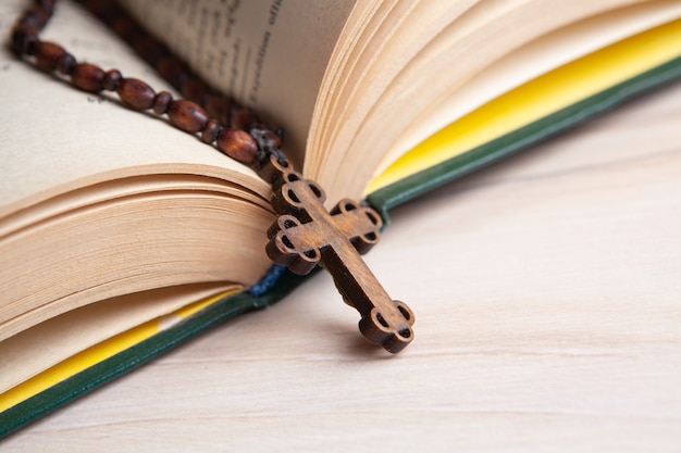 Wooden cross on the book