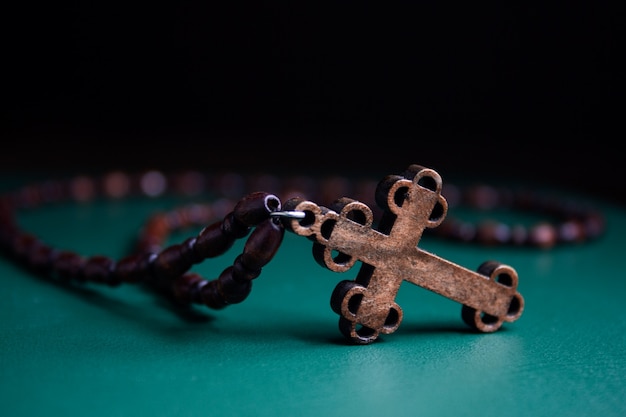 Wooden cross on green surface