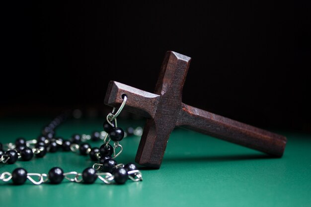 Wooden cross on green surface