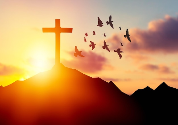 The wooden cross on a mountain with a sunset background