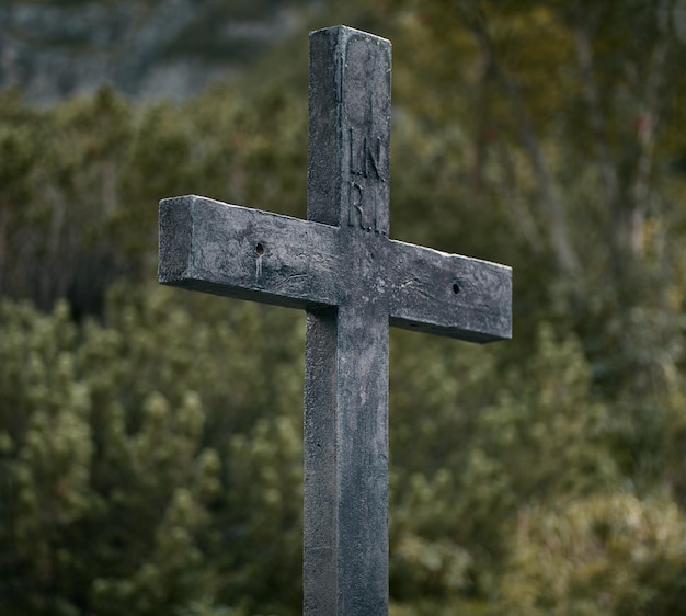 A wooden cross in the mountains on a tourist track