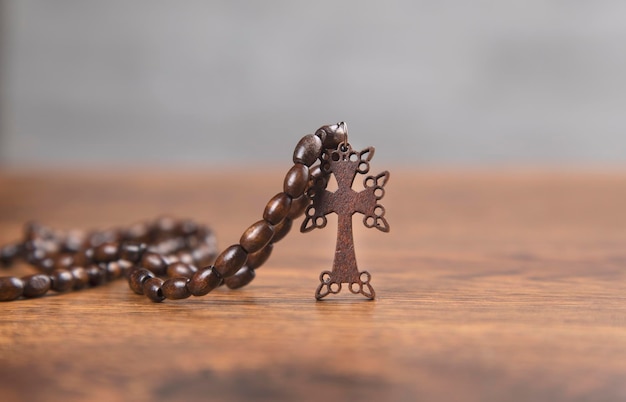 Wooden cross on the wooden background