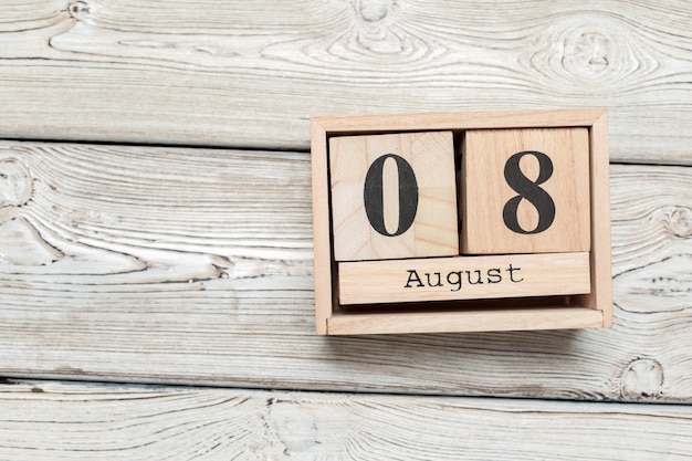 Wooden cube shape calendar for AUG 8 on wooden