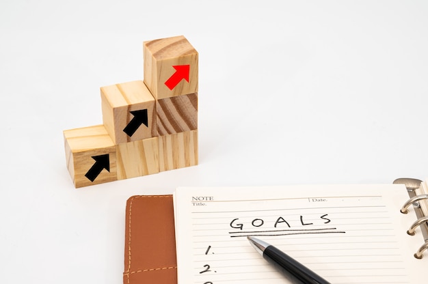 写真 目標と成功の目標リストと矢印のビジネスコンセプトと木製の立方体の階段