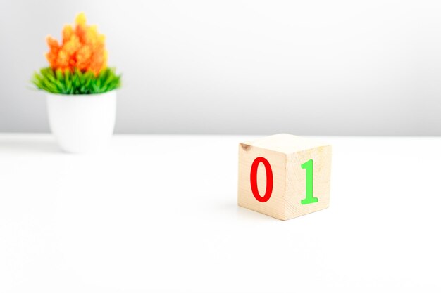 a wooden cube on a white table with text true false concept of development and coding programmer software app prototype nobody logic copy space on right for a design or text gray background
