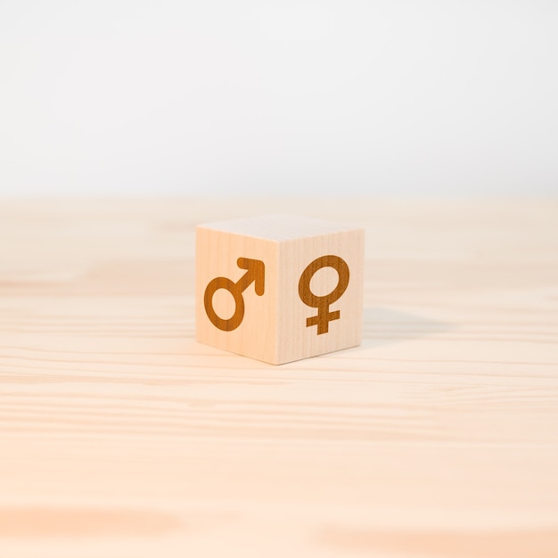 Wooden cube with male and female symbols