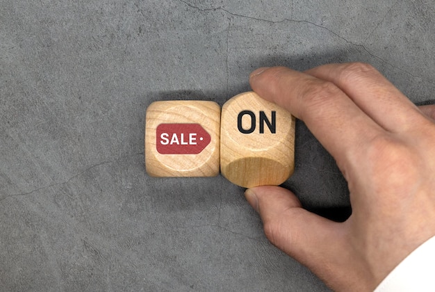 A wooden cube with a sales word written on it