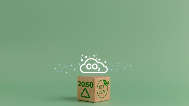 Photo wooden cube with the symbol of co2 emissions net zero by 2050 carbon neutral net zero greenhouse gas emissions target climateneutral longterm strategy no toxic gases